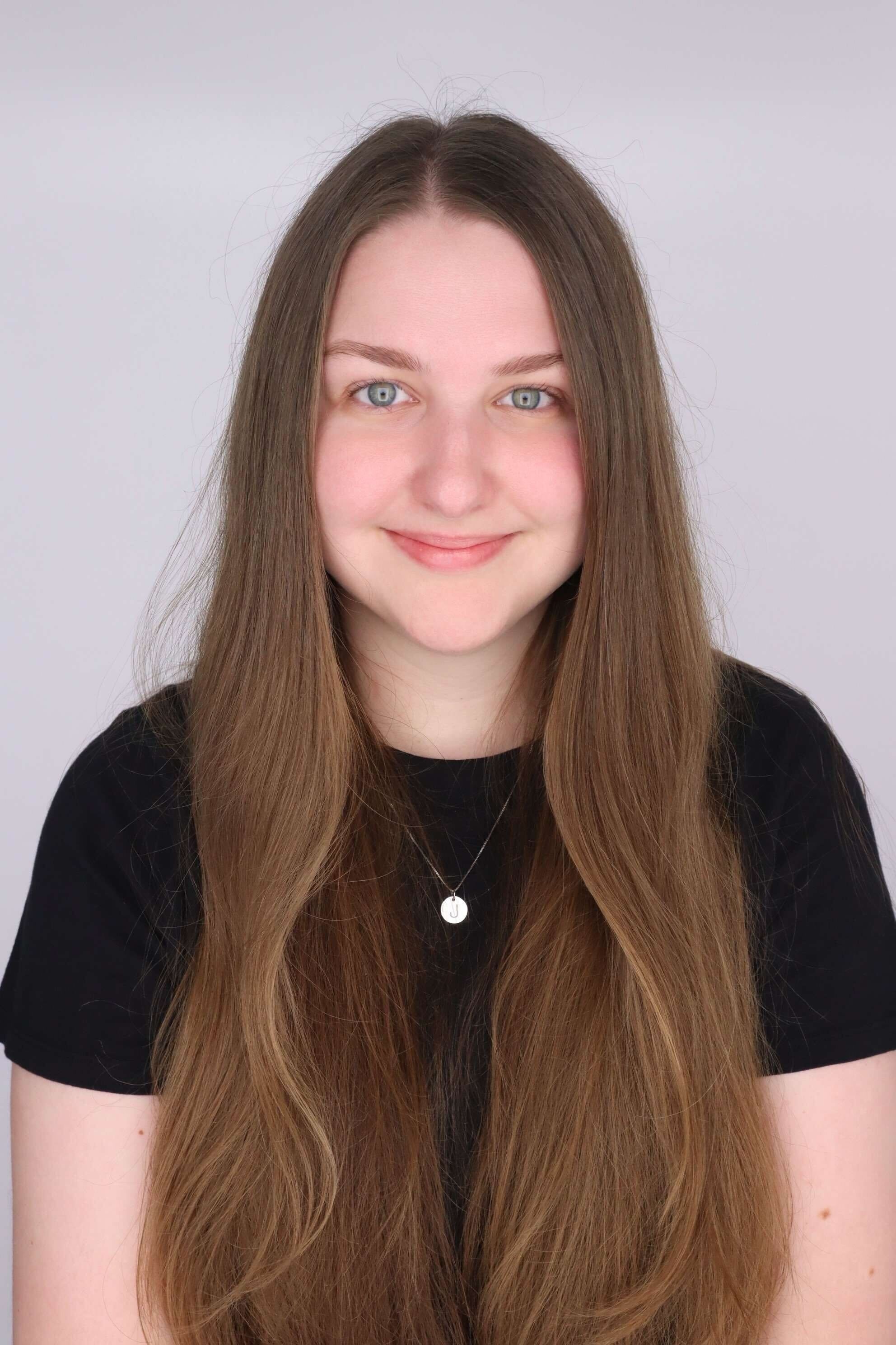 Portrait of Ms. Moyer smiling in a black shirt.